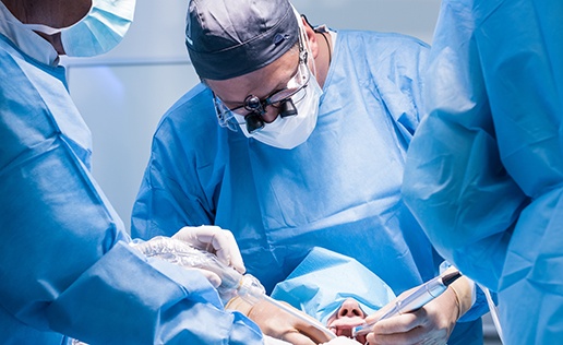 an oral surgeon placing a dental implant 