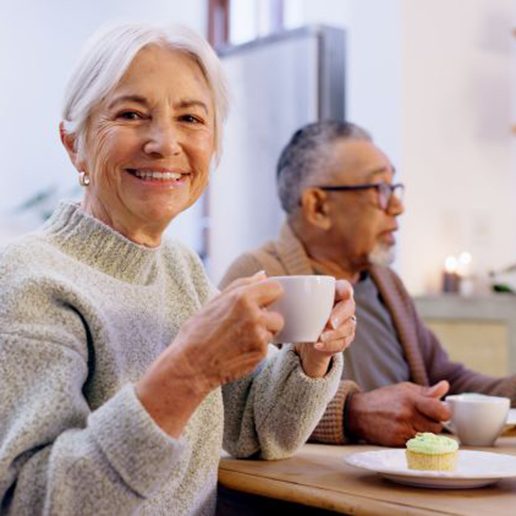 Happy senior woman enjoying a meal with friends