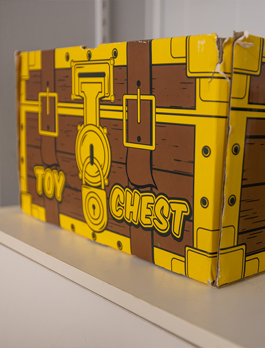 Cardboard box painted like toy chest in children's dentist office in Whiting