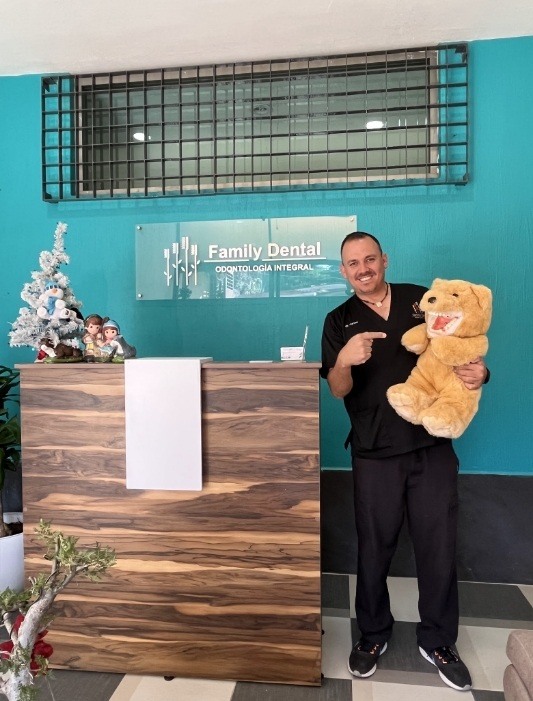 Whiting dentist holding a teddy bear with a set of false teeth