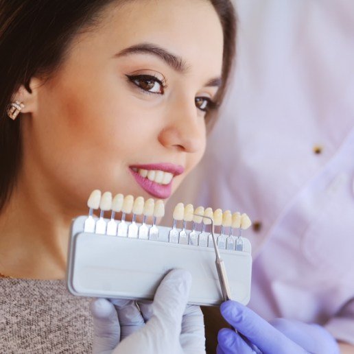 Young woman looking at dental veneers in Whiting