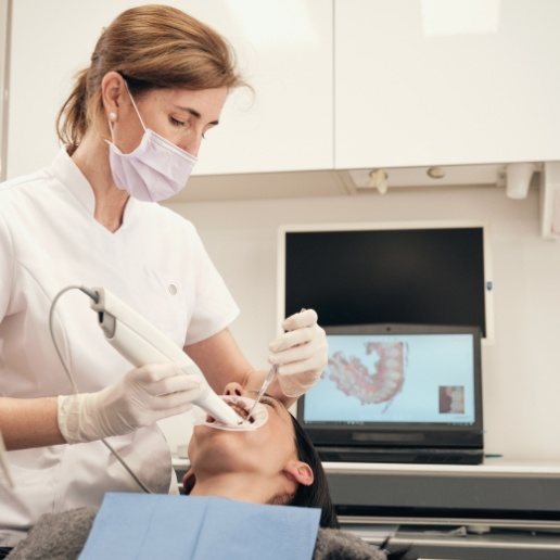 Dental team member taking digital images of a patient's mouth