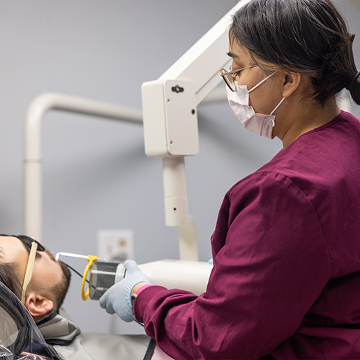 Dental team member taking dental x rays of a patient