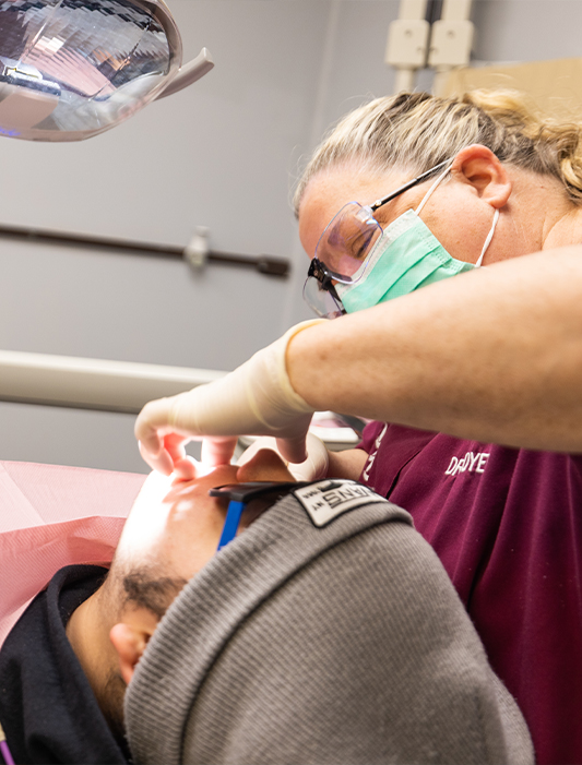 Dentist providing gum disease treatment in Whiting to a patient