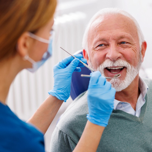 Man smiles at dentist