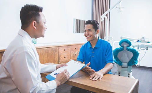 man talking to dentist about finances