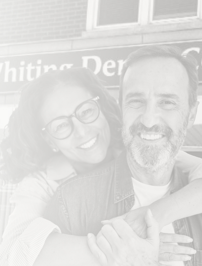 Man and woman hugging in front of Whiting Indiana dental office