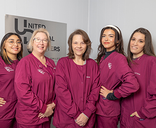 Several dental team members posing at United Dental Centers of Whiting