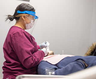 Dental team member treating a patient