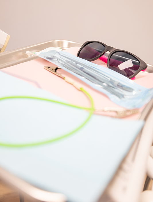 Tray with sunglasses and dental tools in Whiting dental office