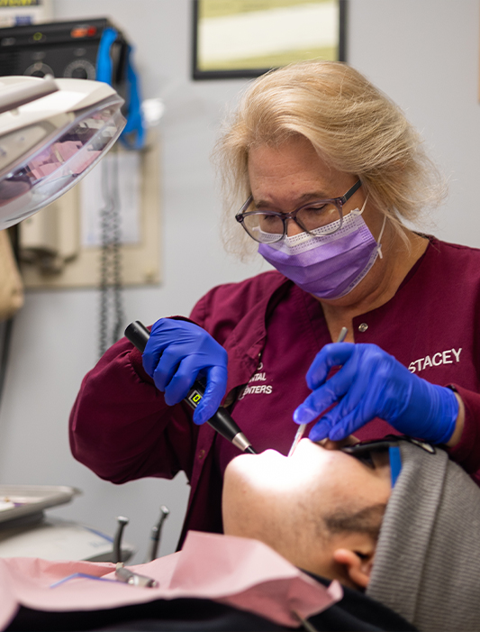 Dental team member giving patient preventive dental exam in Whiting