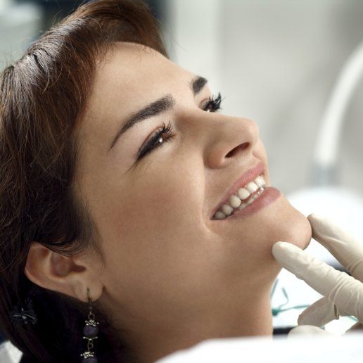 Young woman grinning in dental chair