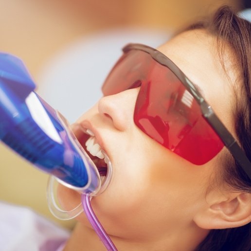 Girl receiving a fluoride treatment from her dentist