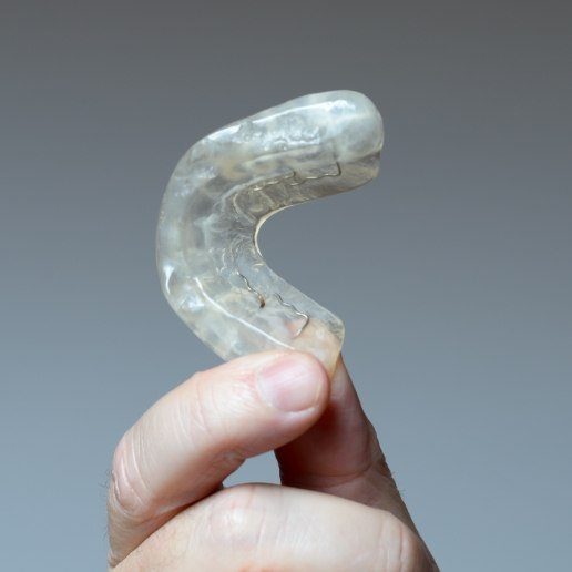 Person holding a dental nightguard