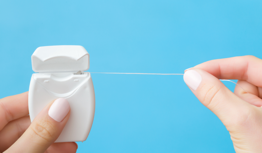 Hands holding dental floss